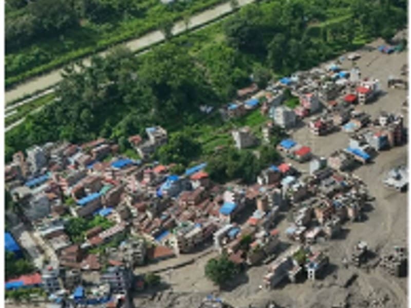 Aerial view of a settlement buried under flood debris and silt